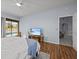 Bright main bedroom features hardwood floors, ceiling fan, and views of the pool at 821 Greenview Dr, Apollo Beach, FL 33572