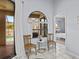 Bright sitting area with white tile floors and arched window overlooking the pool at 821 Greenview Dr, Apollo Beach, FL 33572