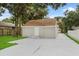 Rear of home showcasing a wide driveway leading to a private entrance and ample parking space at 1906 E Ida St, Tampa, FL 33610