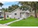 Cozy single-Gathering home with a lush green lawn, complemented by a neat walkway to the front door at 1906 E Ida St, Tampa, FL 33610