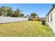 Large, private backyard with well-maintained lawn and a white wooden fence for privacy at 12877 Gorda W Cir, Largo, FL 33773