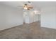 Bright living room with tile flooring, a ceiling fan, and an open layout flowing into other areas of the home at 3207 33Rd Street W Ct, Bradenton, FL 34205