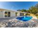 Backyard features a sparkling blue pool with a covered patio and manicured lawn at 3207 33Rd Street W Ct, Bradenton, FL 34205