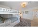 Bright bedroom with a bunk bed, plush gray rug and modern light fixture at 7746 Westmoreland Dr, Sarasota, FL 34243