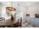 Bright breakfast nook with a round wood table, decorative chandelier, and stylish blue cabinetry at 7746 Westmoreland Dr, Sarasota, FL 34243