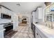 Modern kitchen with stainless steel appliances, white countertops, and ample cabinet space at 7746 Westmoreland Dr, Sarasota, FL 34243