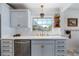 Bright kitchen featuring white countertops, blue cabinetry, and stainless steel appliances at 7746 Westmoreland Dr, Sarasota, FL 34243