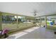 Enclosed sunroom with tiled floors overlooking a spacious backyard and lush landscaping at 7746 Westmoreland Dr, Sarasota, FL 34243