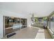 Enclosed sunroom with tiled floors and sliding glass doors leading to the interior living space at 7746 Westmoreland Dr, Sarasota, FL 34243