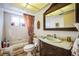 The bathroom features a vanity with a mirror and a bathtub next to the window at 8700 Powderhorn Row, Hudson, FL 34667