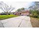 Charming single-story home with an attached garage and concrete driveway, surrounded by a lush green lawn at 8700 Powderhorn Row, Hudson, FL 34667