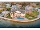 Waterfront home featuring a private pool, patio, and manicured lawn at 1903 Gulfview Dr, Holiday, FL 34691