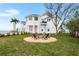 Stunning backyard with a fire pit and green lawn, next to the water at 1903 Gulfview Dr, Holiday, FL 34691