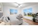 Bright bedroom features large windows, a ceiling fan, and a comfortable seating area at 1903 Gulfview Dr, Holiday, FL 34691