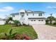 Beautiful two-story home boasts a three-car garage and brick-paved driveway at 1903 Gulfview Dr, Holiday, FL 34691