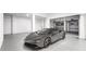 Spacious garage with sleek gray sports car and ample storage space at 1903 Gulfview Dr, Holiday, FL 34691