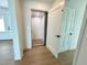 Bright hallway features an elevator and wood floors, showcasing accessibility and modern design at 1903 Gulfview Dr, Holiday, FL 34691