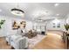 Spacious living room boasts a hardwood floor, neutral paint, and modern light fixtures at 1903 Gulfview Dr, Holiday, FL 34691