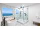 Luxurious main bathroom with freestanding tub, glass shower, and ocean views at 1903 Gulfview Dr, Holiday, FL 34691