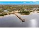 Aerial view of Crystal Beach pier extending into the calm, blue waters at 606 Indiana Ave, Crystal Beach, FL 34681