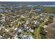 Aerial view of the neighborhood with lush trees, a lake and beautiful houses at 606 Indiana Ave, Crystal Beach, FL 34681