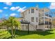 Multi-level backyard with outdoor living areas, including a covered patio and staircase, perfect for entertaining guests at 606 Indiana Ave, Crystal Beach, FL 34681