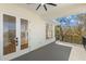 Balcony view with french doors, black railings, and picturesque view beyond at 606 Indiana Ave, Crystal Beach, FL 34681
