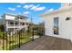 Spacious balcony with black metal railings and views of the surrounding neighborhood at 606 Indiana Ave, Crystal Beach, FL 34681