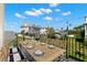 Balcony with outdoor dining set and a scenic view of neighborhood homes, offering a relaxing spot at 606 Indiana Ave, Crystal Beach, FL 34681