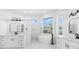 Spacious bathroom featuring a soaking tub, walk-in shower, and double sink vanity at 606 Indiana Ave, Crystal Beach, FL 34681