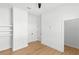 Bedroom featuring hardwood floors, ceiling fan, and ample closet space at 606 Indiana Ave, Crystal Beach, FL 34681