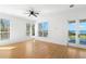 Light-filled bedroom with hardwood floors, multiple windows, and a balcony door at 606 Indiana Ave, Crystal Beach, FL 34681