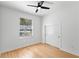 A bright bedroom features minimalist design and a modern ceiling fan at 606 Indiana Ave, Crystal Beach, FL 34681