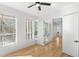 Bedroom featuring hardwood floors, ceiling fan, and ample natural light at 606 Indiana Ave, Crystal Beach, FL 34681