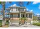 Beautiful two-story home featuring balconies, a two-car garage, manicured yard, and classic architectural details at 606 Indiana Ave, Crystal Beach, FL 34681
