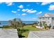 Coastal home exterior boasting stunning waterfront views and lush green lawns at 606 Indiana Ave, Crystal Beach, FL 34681