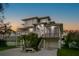 Stunning modern home with a raised foundation, multiple balconies, and a grand staircase at 606 Indiana Ave, Crystal Beach, FL 34681