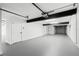 Spacious garage featuring painted floor, white walls, and an automatic overhead door at 606 Indiana Ave, Crystal Beach, FL 34681