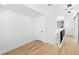 Bright hallway with hardwood floors and stairs with modern black metal and glass railing at 606 Indiana Ave, Crystal Beach, FL 34681