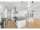 Bright and spacious kitchen featuring white cabinetry, a center island, and stainless steel appliances at 606 Indiana Ave, Crystal Beach, FL 34681