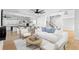 Bright, open-concept living room and kitchen with hardwood floors and modern furnishings at 606 Indiana Ave, Crystal Beach, FL 34681