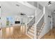 Open-concept living area with a fireplace and staircase with black metal handrails at 606 Indiana Ave, Crystal Beach, FL 34681