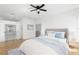 Inviting main bedroom featuring a neutral color palette, hardwood floors, and a view of the attached bathroom at 606 Indiana Ave, Crystal Beach, FL 34681