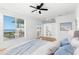 Relaxing main bedroom with a large window overlooking the water and an attached balcony at 606 Indiana Ave, Crystal Beach, FL 34681