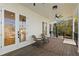 Inviting porch with comfortable seating and french door access to the home's interior at 606 Indiana Ave, Crystal Beach, FL 34681