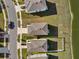 An aerial view of houses and lawns and the shadows they cast on a sunny day in this community at 10523 Penny Gale Loop, San Antonio, FL 33576