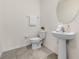 Bathroom with pedestal sink, neutral tile flooring, and modern fixtures at 10523 Penny Gale Loop, San Antonio, FL 33576