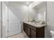 Bathroom featuring a double sink vanity and tile flooring at 10523 Penny Gale Loop, San Antonio, FL 33576