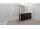 Bathroom with a double sink vanity, dark wood cabinets, and a walk-in shower at 10523 Penny Gale Loop, San Antonio, FL 33576