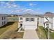 Aerial front view of a two-story home with a two-car garage, showcasing curb appeal at 10523 Penny Gale Loop, San Antonio, FL 33576